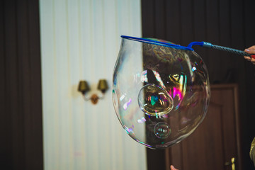 A magician pushing her hand through the bubble wall