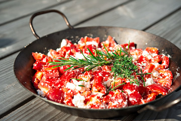 pepper and feta with rosemary and thyme in iron pan