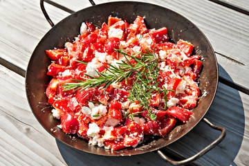pepper and feta with rosemary and thyme in iron pan