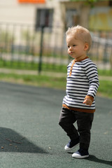 Fototapeta premium One year old baby boy toddler at playground