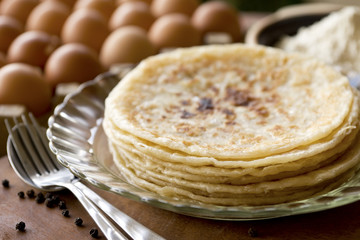 Warm roti paratha is on a plate in a kitchen filled with natural light