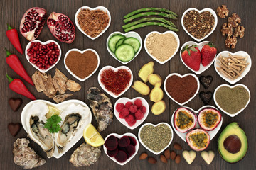 Healthy aphrodisiac food collection to boost sexual health on oak wood background.