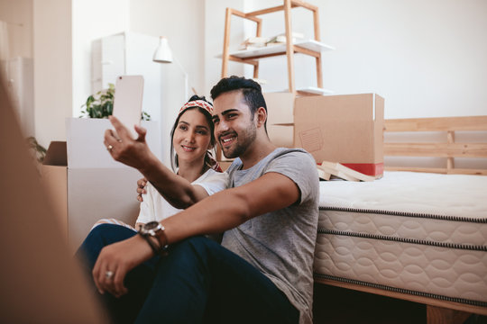 Couple moving in new home and taking selfie