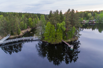 Islet with dock and boat on the mirror-like surface of the lake