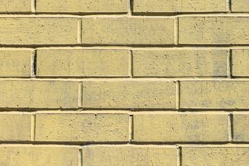 Yellow painted brick wall texture