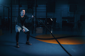 Fototapeta premium Sportsman on training, workout with battle ropes