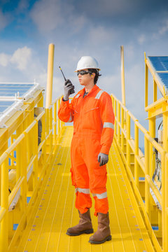 Offshore Oil Rig Worker Use Radio To Communication Between Wellhead Platform To Central Processing Platform.