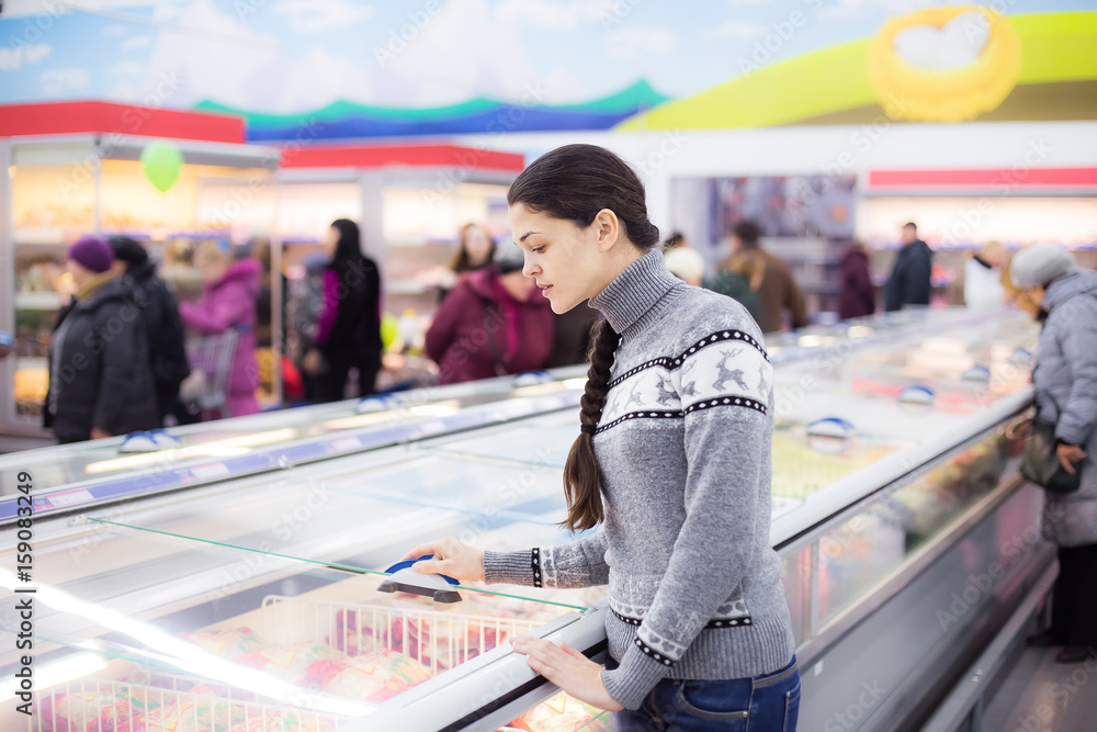 Sticker the girl makes a purchase at the grocery hypermarket