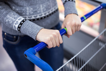 Woman with shopping cart, close up