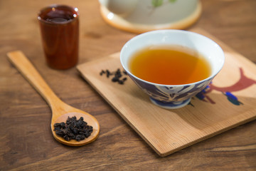 Tea cup and teapot on wooden table , close-up.