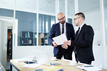 Employer showing business contract to co-worker