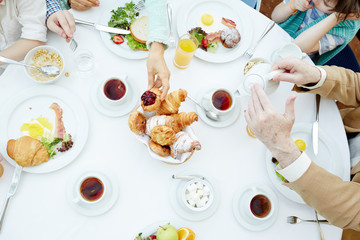People having meals and tea with pastry