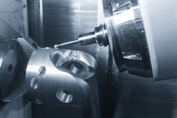 The 5-axis CNC  milling machine  chamfering  the automotive part with the end-mill...