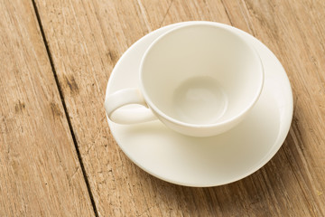Empty white ceramic coffee mug on wooden background