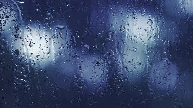 Raindrops on window surface after heavy rain
