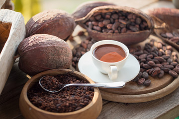 Fresh chocolate and.Liquid chocolate in white ceramic glass.on cocoa beans background.