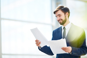 Happy ceo reading papers or contracts