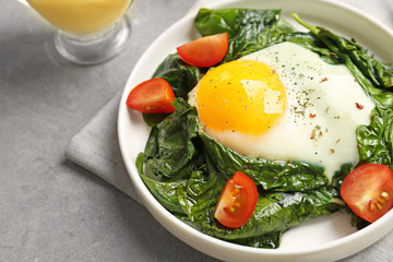 Delicious eggs Florentine with tomatoes, close up