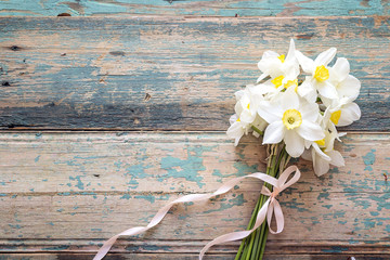 Bouquet of daffodils flowers on wooden background.