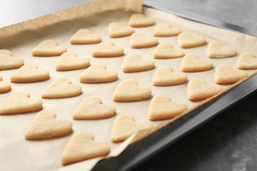 Raw butter cookies on baking tray, closeup