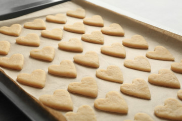 Raw butter cookies on baking tray, closeup