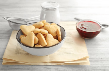 Bowl with heart shaped butter cookies on table