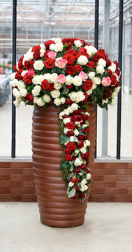 Big vase with beautiful roses in flower shop