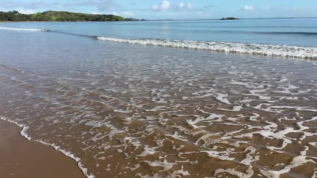 Landscape of waves breaking on empty beach