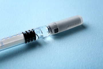 Fototapeta premium Medical syringe on color background