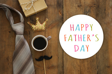 gift box, glitter crown, necktie and cup of coffee. Father's day concept