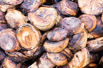 Close-up view. Rubber cup lump dry with dark brown. As grained.