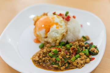 Rice topped with stir-fried pork and basil and fired egg