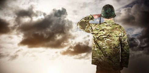 Composite image of rear view of military soldier saluting