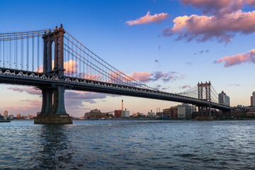 Manhattan Bridge (long-span suspension bridge) over the East River at sunset with view of Brooklyn....