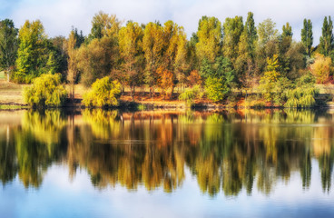 Fototapeta na wymiar reflection. On the bank of the autumn river