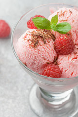 Homemade raspberry ice cream with chocolate and mint. A refreshing dessert for gourmets. Selective focus