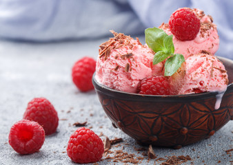 Homemade raspberry ice cream with chocolate and mint. A refreshing dessert for gourmets. Selective focus