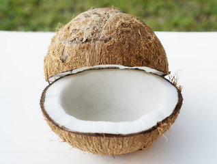 Closeup of coconuts on the white isolated over blurred grass background