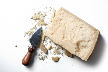 Slice of parmesan cheese with knife over white background