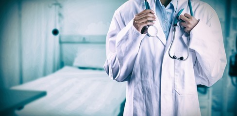 Composite image of asian doctor holding stethoscope