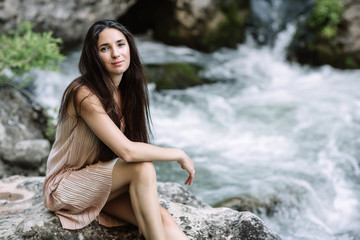 Woman enjoying daisy field, nice female lying down in meadow of flowers, pretty girl relaxing outdoor, having fun, holding plant, happy young lady and spring green nature, harmony concept