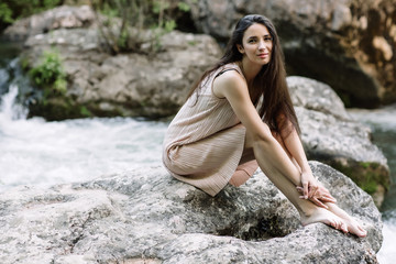 Woman enjoying a field of daisies, beautiful woman lying in a meadow of flowers, beautiful girl relaxing outdoors, having fun, holding plant, happy young lady and spring-green nature, harmony concept.
