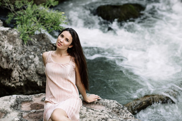Woman enjoying a field of daisies, beautiful woman lying in a meadow of flowers, beautiful girl relaxing outdoors, having fun, holding plant, happy young lady and spring-green nature, harmony concept.
