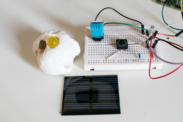 Fototapeta na wymiar IoT with solar panel, led, button humidity sensor and a stone