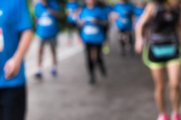 Blurred leg movement marathon running on road