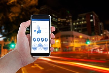 Composite image of cropped hand holding mobile phone