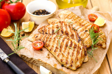 Grilled pork escalopes with rosemary and cherry tomatoes - obrazy, fototapety, plakaty