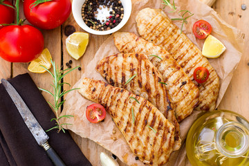 Grilled pork escalopes with rosemary and cherry tomatoes