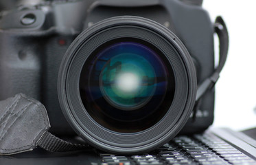 Close-up DSLR Camera lens on laptop.