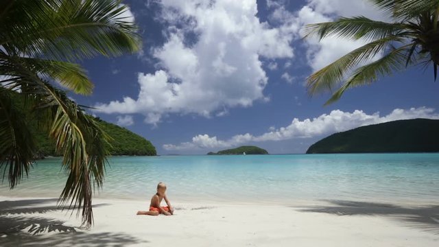 young boy playing in the sand at perfect tropical beach, maho bay, st john